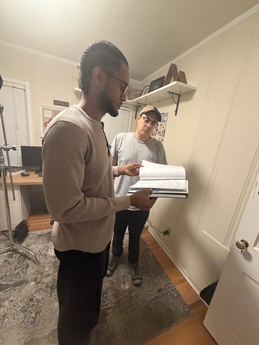 Austin and a collaborator read through the script pages on their feet.