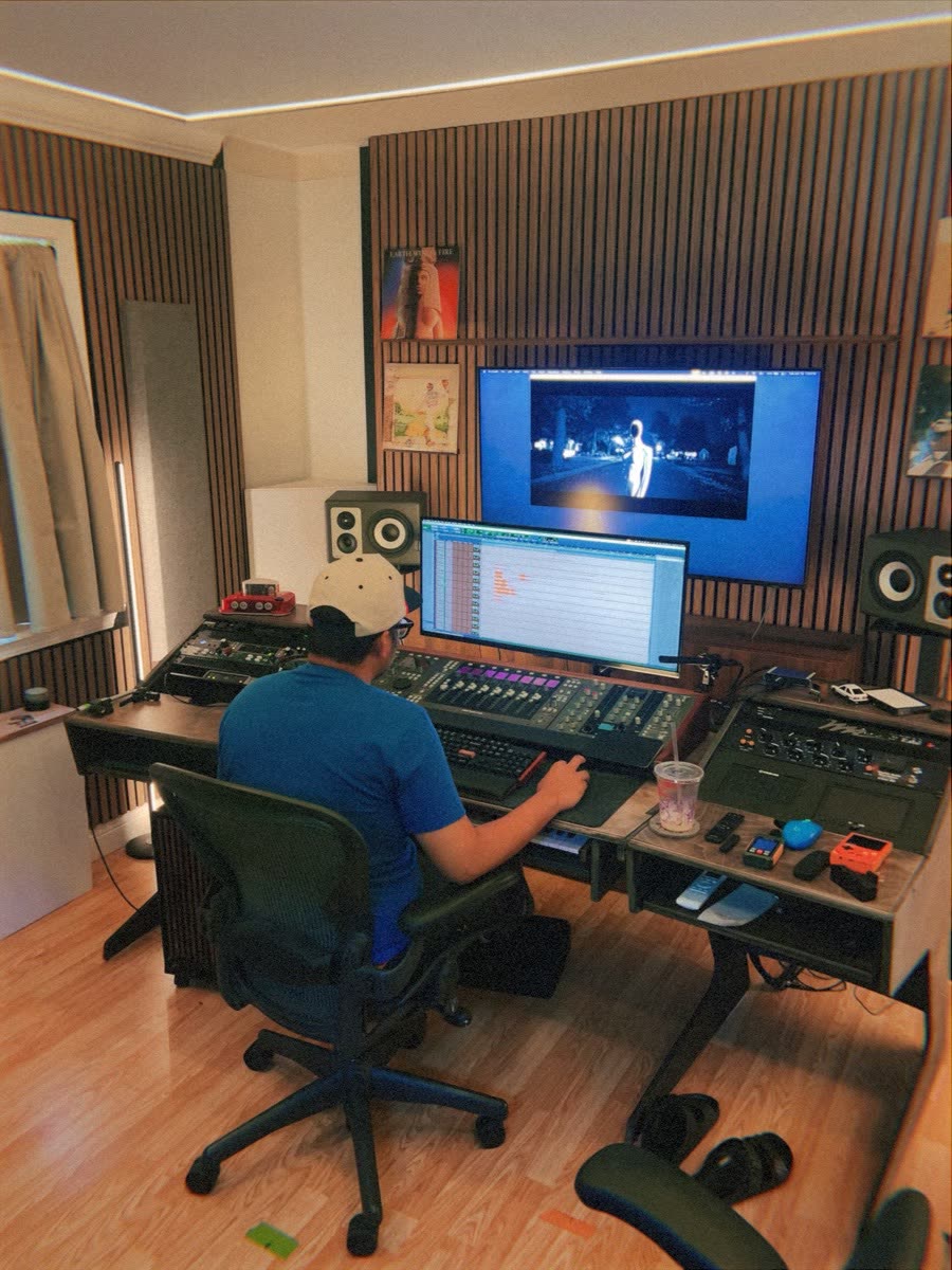 The mix: an engineer at the console in a dark studio, a frame of the film glowing above.