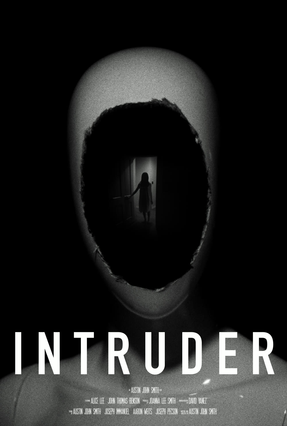 INTRUDER one-sheet: a mannequin head with a torn black hole for a face; inside the hole, a woman stands in a distant doorway.